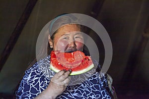 The extreme north  Yamal  life of Nenets people  the dwelling of the peoples of the north  a woman eats a watermelon for the first