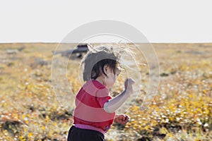 The extreme north  Yamal  the past of Nenets people  the dwelling of the peoples of the north  a girl playing near the yurts in