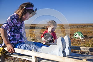 The extreme north  Yamal  the past of Nenets people  the dwelling of the peoples of the north  a girl playing near the yurts in