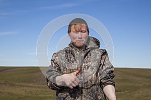 The extreme north, Yamal, the preparation of deer meat, the male reindeer breeder eats fresh meat, venison