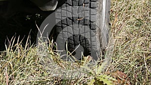 Extreme off road behind unrecognizable car in grass and mud