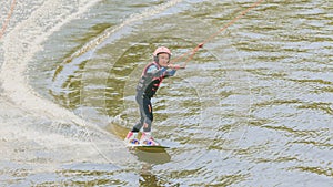 Extreme Park, Kiev, Ukraine, 07 may 2017 - a little girl to ride a Wakeboard. Photo of grain processing