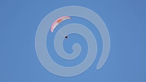 Extreme people go paragliding, flying high in blue sky, enjoying adventure sport