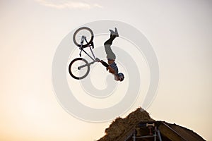 Extreme rider falling while making a bike jump.