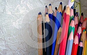 Extreme shallow of depth. Bunch of colorful pencils kept against white designer background