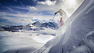 Extreme skier charging down steep slope