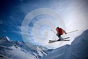 Extreme skier jumping off the cliff