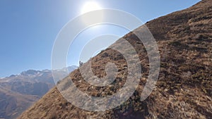 Extreme speed race mountain motorbike sports man riding up slope to summit at sunny sky aerial view