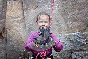 Extreme sport, active lifestyle, kid with a rope engaged in the sports of rock climbing on the rock