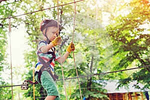 Extreme sport in adventure park. Climbing the rope park. Summer camp