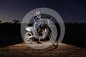 Extreme sport, portrait and man with dirt bike, confidence and gear for competition, race or challenge. Adventure