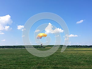 Extreme sports - the paratrooper lands on the ground