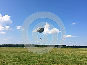 Extreme sports - the paratrooper lands on the ground