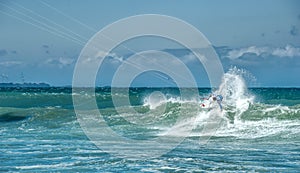 Extreme sports photography of athlete on kiteboard surfing photo