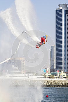 Extreme sportsman on flaybord performs tricks