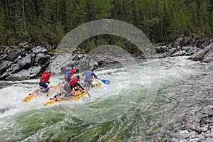 Extreme sportsmen go through the difficult turbine rapid on a catamaran