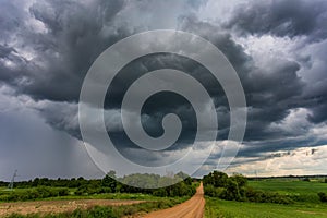 Extreme thunderstorm clouds moving over fields, climate change concept