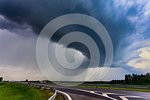 Extreme thunderstorm shelf cloud moving over fields, climate change concept