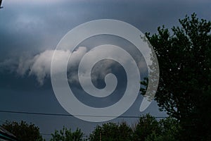 Extreme thunderstorm shelf cloud. Summer landscape of severe weather