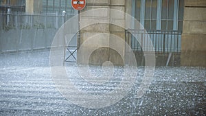 Extreme weather hail rain storm on the streets of Paris man hiding from hail