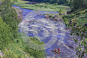 Extreme whitewater rafting trip. A group of people team in sport ÃÂatamarans practise traversing the water rapids of the