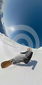 Extreme young snowboarder riding off piste in beautiful sunny British Columbia.