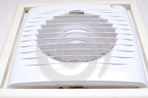 Extremely dirty and dusty white plastic ventilation air grille at home close up, harmful for health, house cleaning concept
