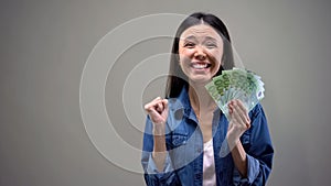 Extremely happy woman holding euros banknotes, good salary, employment concept