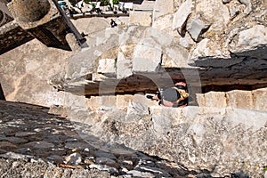 Extremely narrow steps viewed from above with a woman walking down