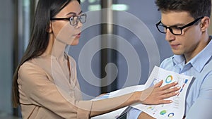 Extremely unhappy lady boss criticizing male employee, displeased with work