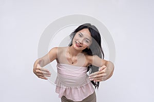 A extroverted and friendly young asian woman offering an embrace. A platonic wholesome hug.  on a white background photo
