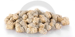 Extruded wheat bran pellets isolated on white.