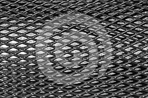 Exture of cambered metal perforated netted sheet with lighting effect.Grunge netted metal grill texture.