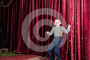 Exuberant little boy performing on stage