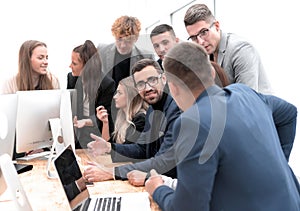 Exultant business team looking at the screen of the office computer
