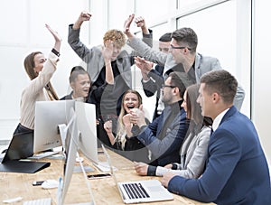 exultant business team looking at the screen of the office computer