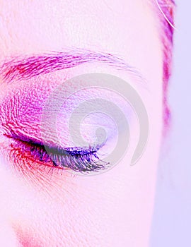 Eye of an attractive young woman closed