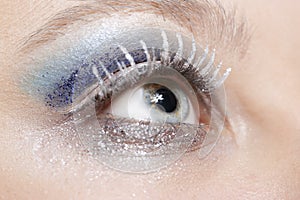 Eye with blue and silver sparkle make-up