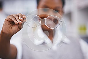 Eye care, hand and woman holding frame in clinic for health, vision and medical exam for poor sight. Eyesight, girl with