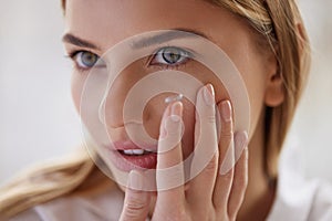 Eye care. Smiling Woman With Contact Eye Lens on Finger Closeup