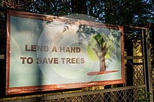 Eye-catching billboard urging environmental action: \'Lend A Hand To Save Trees,\'