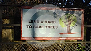 Eye-catching billboard urging environmental action: \'Lend A Hand To Save Trees,\'