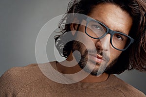 Eye catching frames that suit his face. Studio shot of a handsome young man wearing glasses against a gray background.