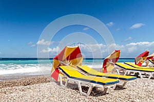 Eye catching parasols lying on picturesque pebble Mediterranean