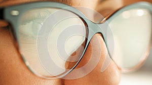 The eye of a computer hacker as he monitors a computer screen.