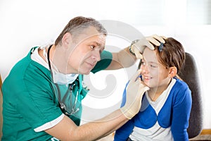 Eye doctor examining young girl patient