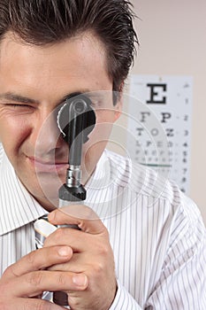 Eye doctor using opthalmoscope