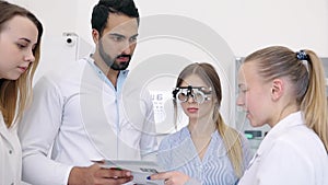 Eye Exam. Doctors Checking Woman Eyesight With Optometry Glasses