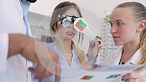 Eye Exam. Doctors Checking Woman Eyesight With Optometry Glasses