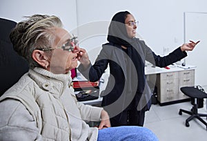 Eye exam, frame and woman reading with optometrist in clinic for vision test, eyesight and optical assessment. Optometry